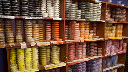 The paint room at Warlukurlangu art centre: a huge variety of paint colours in small pots ready for artists to use.